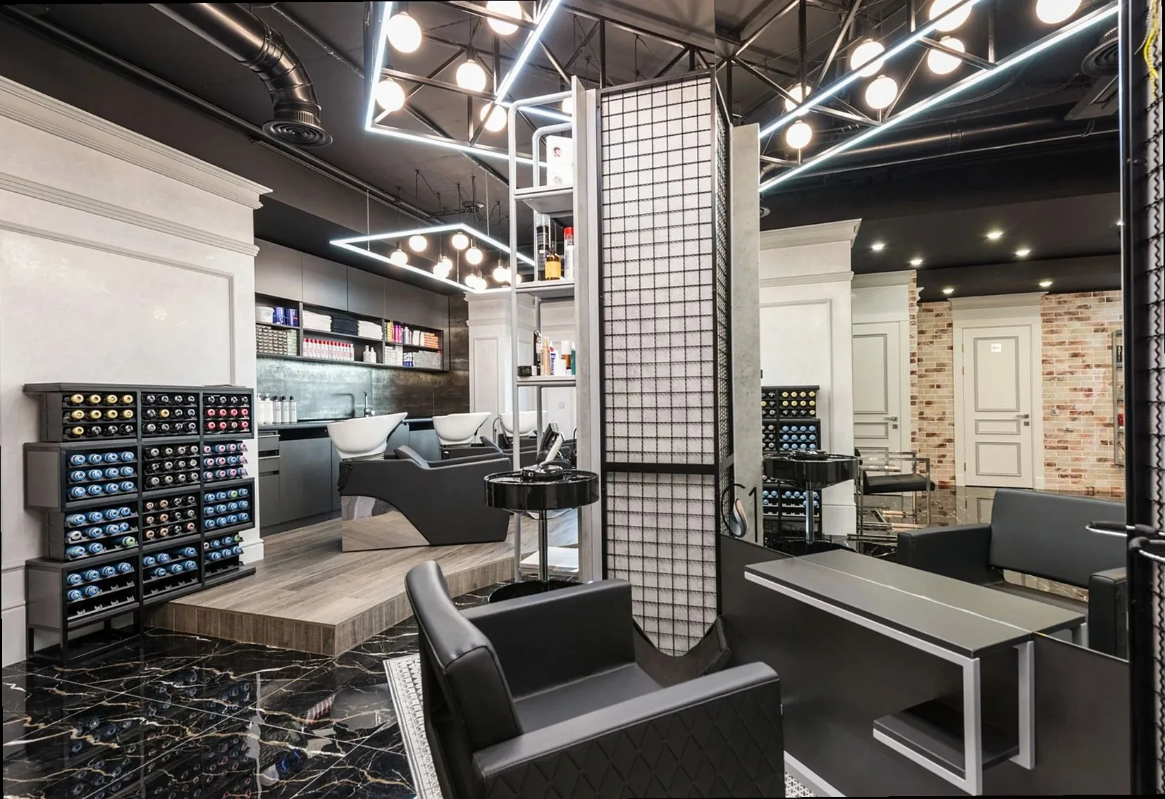 Black leather chair placed against mirror with reflection in stylish beauty salon with backwash chairs and abundance of 